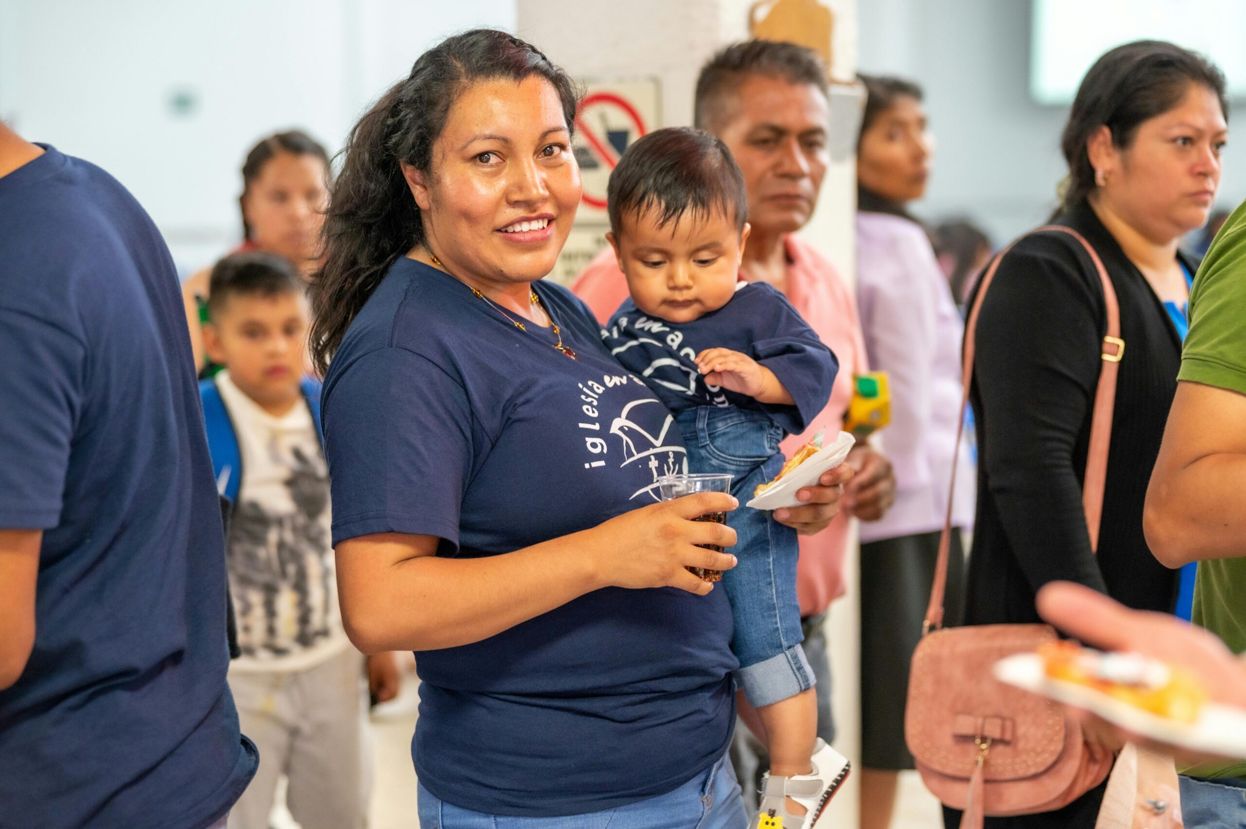 Smiling adults and children gather at a lively community event in Mexico City, CDMX.